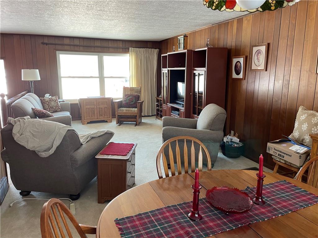 506 Lake Wilhelm Road Sandy Lake, PA 16145 - Photo 20 of 42 a living room with furniture fireplace and a window