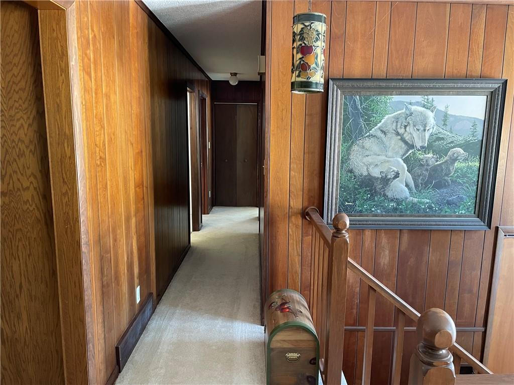 506 Lake Wilhelm Road Sandy Lake, PA 16145 - Photo 23 of 42 a view of a hallway with wooden floor and stairs