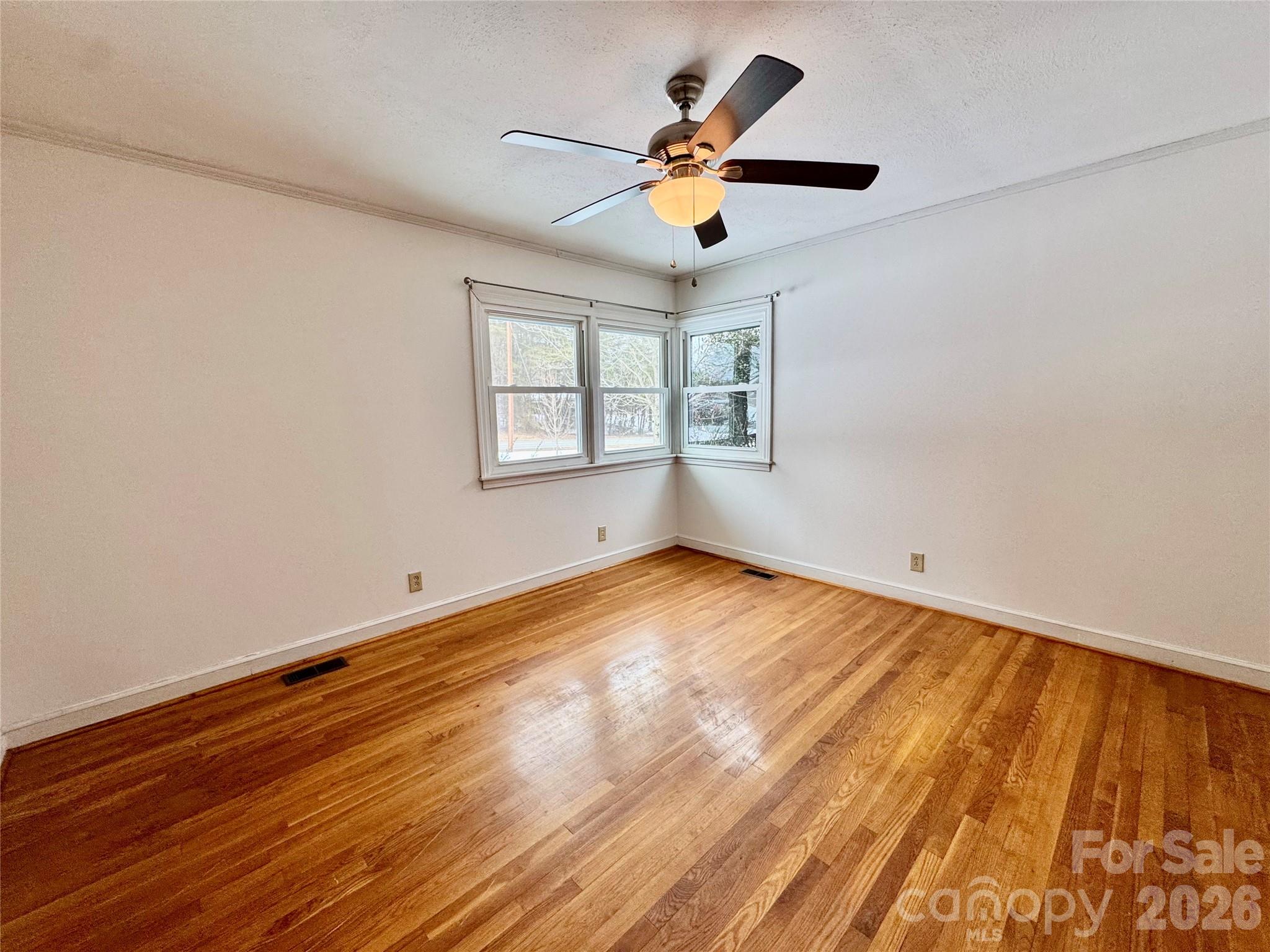 3134 Asbury Church Road Lincolnton, NC 28092 - Photo 13 of 24 an empty room with wooden floor and windows