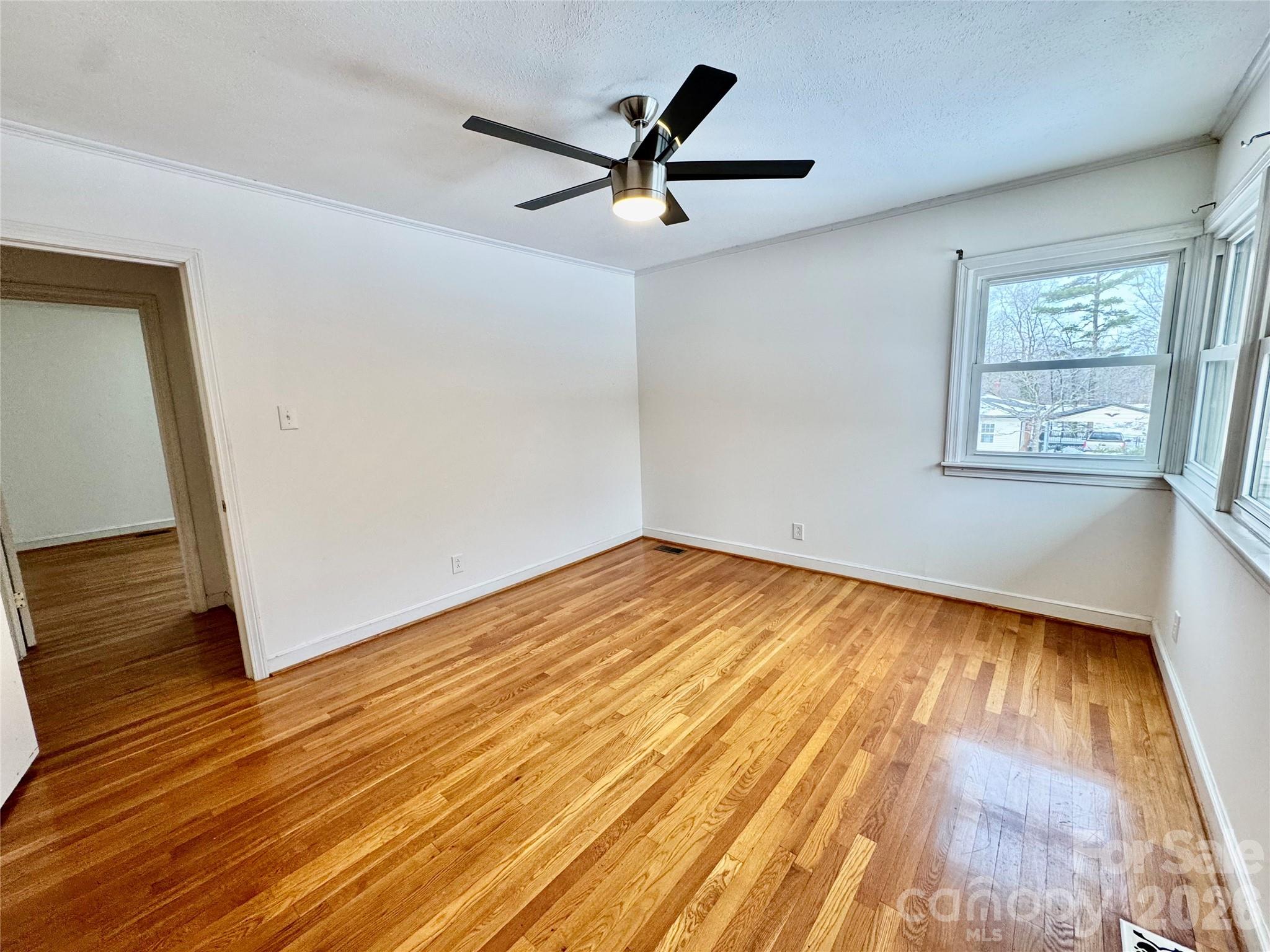 3134 Asbury Church Road Lincolnton, NC 28092 - Photo 15 of 24 a view of empty room with wooden floor and fan