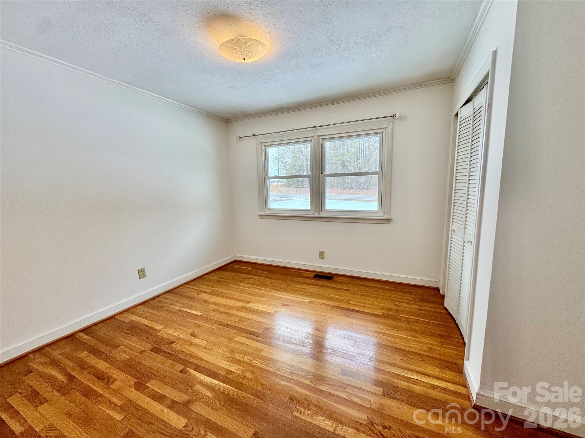 3134 Asbury Church Road Lincolnton, NC 28092 - Photo 17 of 24 an empty room with wooden floor and windows