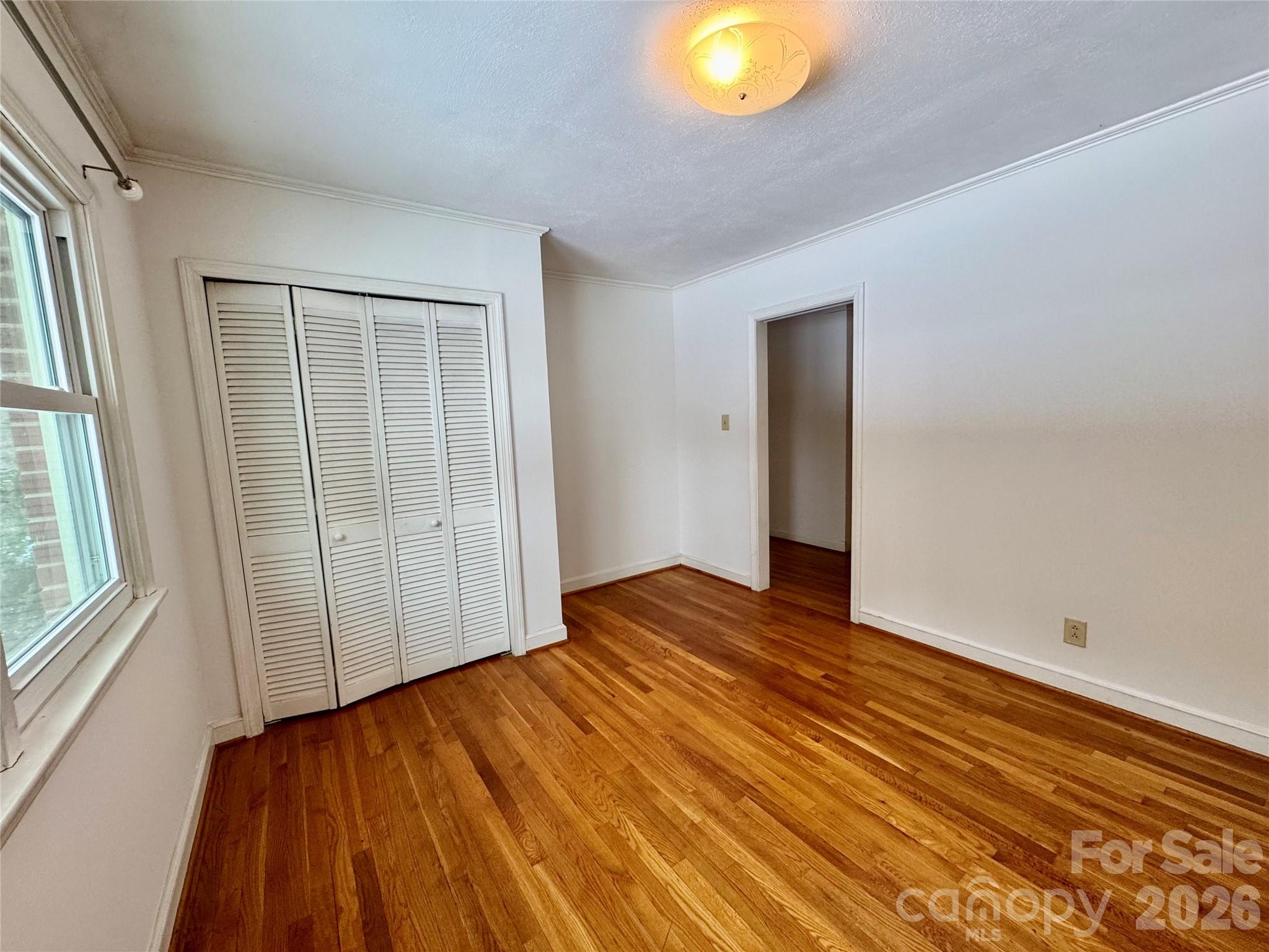 3134 Asbury Church Road Lincolnton, NC 28092 - Photo 18 of 24 an empty room with wooden floor and windows
