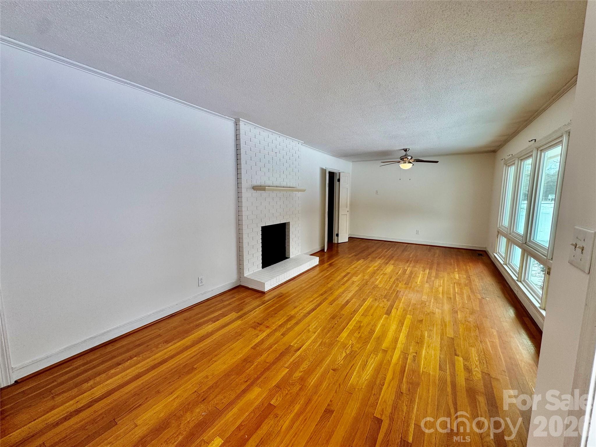 3134 Asbury Church Road Lincolnton, NC 28092 - Photo 3 of 24 a view of empty room with wooden floor and fireplace