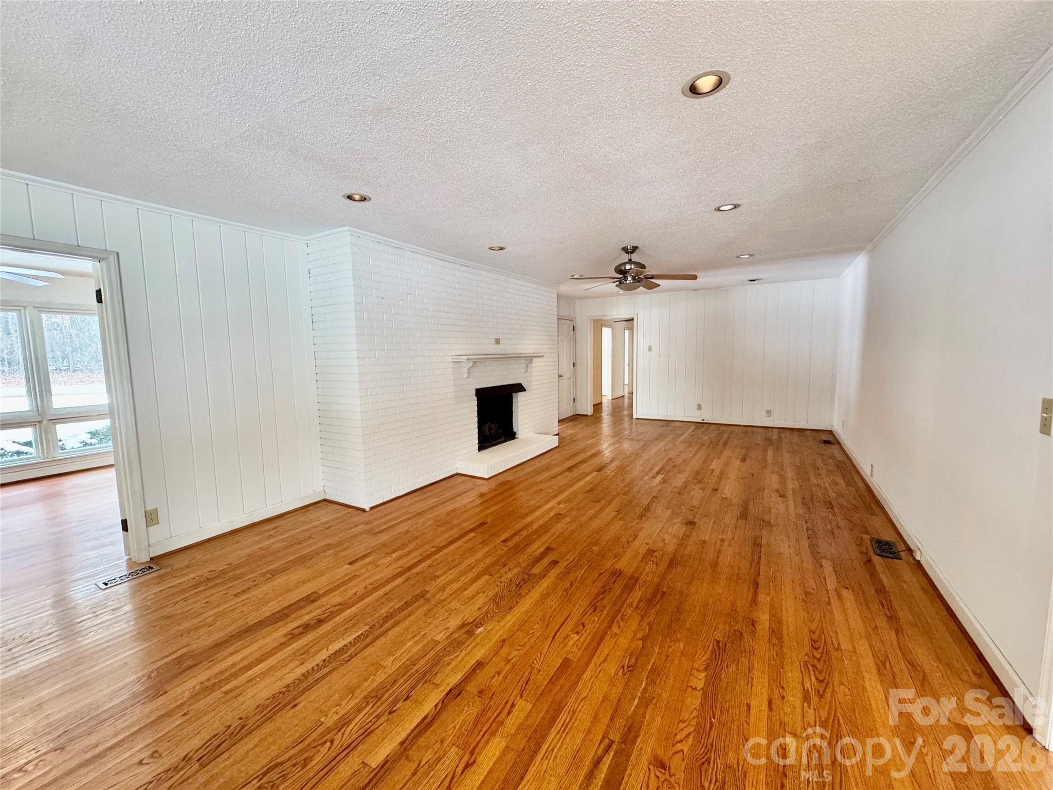 3134 Asbury Church Road Lincolnton, NC 28092 - Photo 5 of 24 wooden floor in an empty room with a fireplace