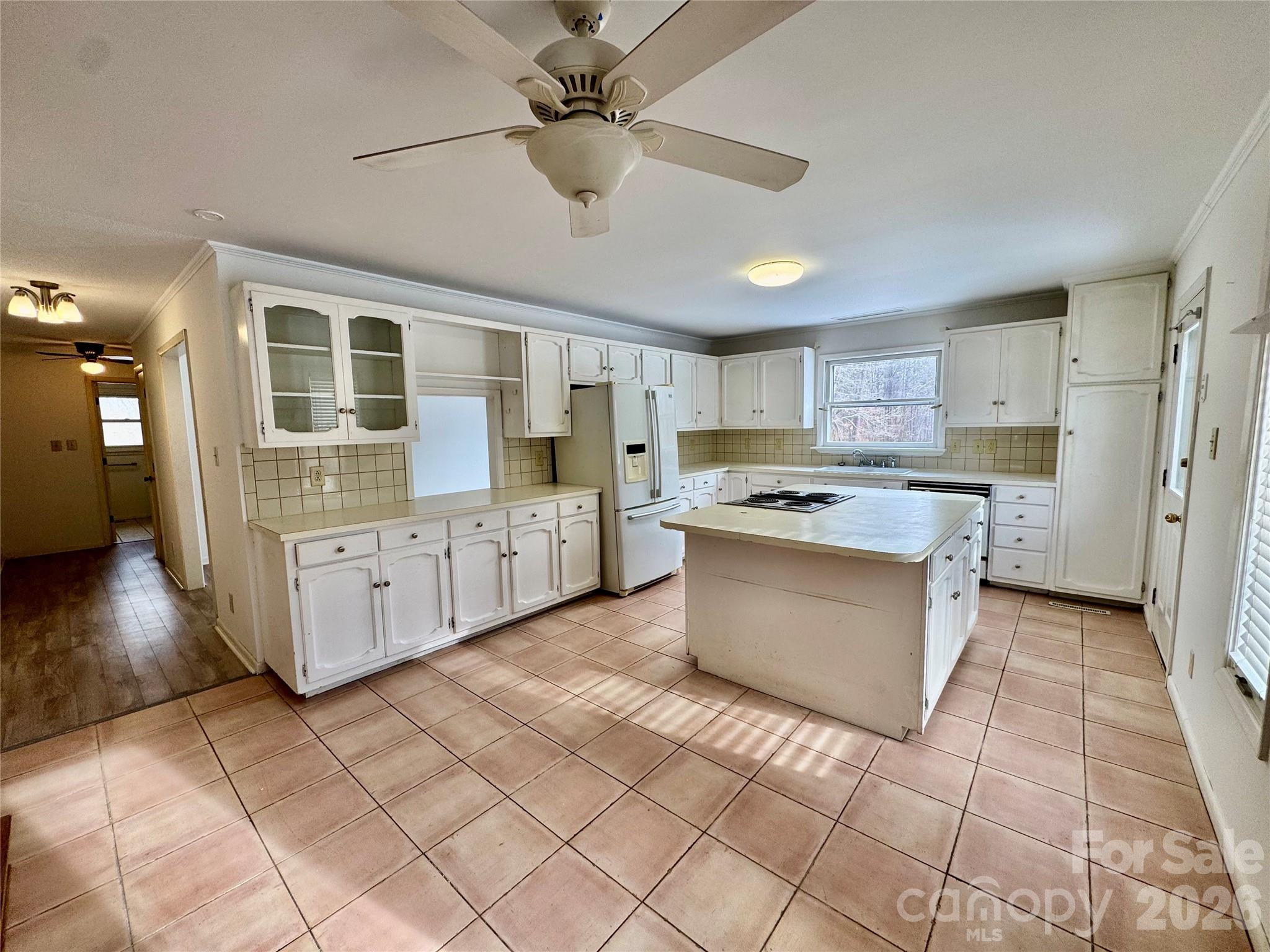 3134 Asbury Church Road Lincolnton, NC 28092 - Photo 7 of 24 a large kitchen with stainless steel appliances kitchen island granite countertop a stove a sink a refrigerator a counter space and cabinets