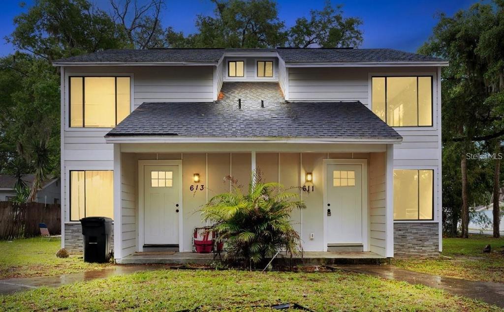 611 Warn Ree Circle New Smyrna Beach, FL 32168 - Photo 1 of 1 a front view of house with yard space and outdoor seating