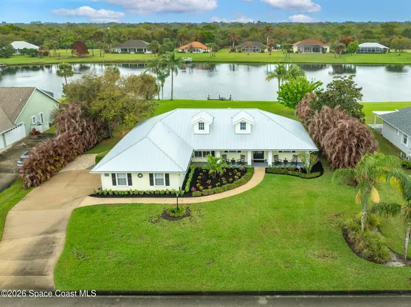 an aerial view of a house with garden space and lake view