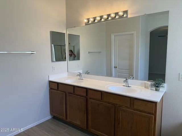 a bathroom with a double vanity sink and mirror