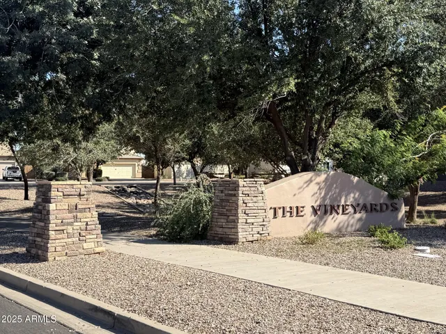 a sign board with buildings in the background
