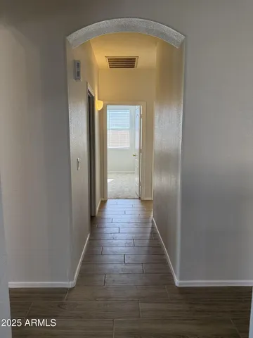 a view of a hallway with wooden floor