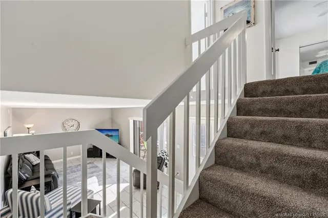 a view of staircase with lots of frames on wall