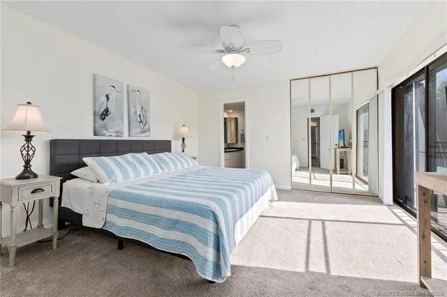 a spacious bedroom with a bed and a lamp