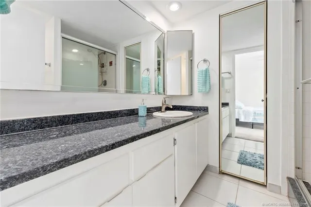 a bathroom with a double vanity sink and a mirror