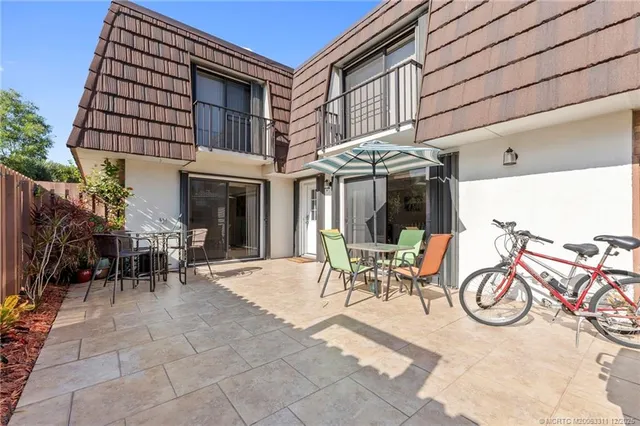 a view of a patio with table and chairs and potted plants