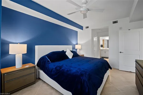 a bedroom with a bed and a lamp