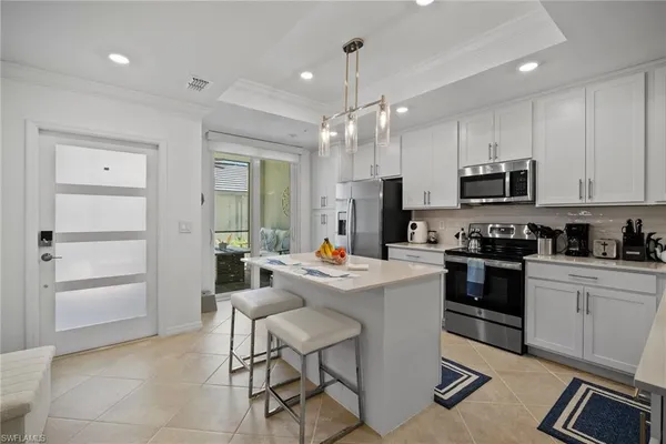 a kitchen that has a lot of cabinets in it and appliances