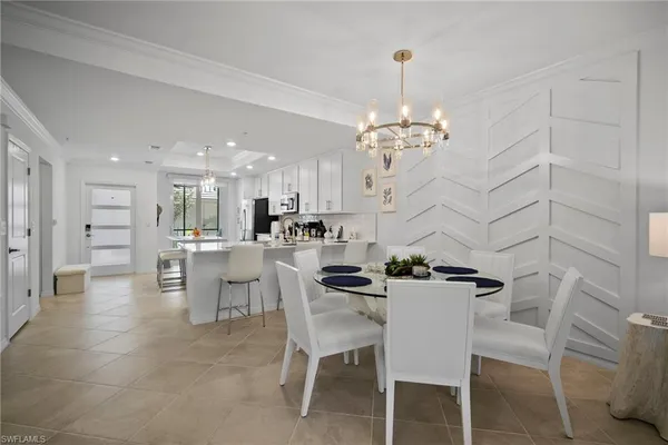 a dining room with furniture and a chandelier
