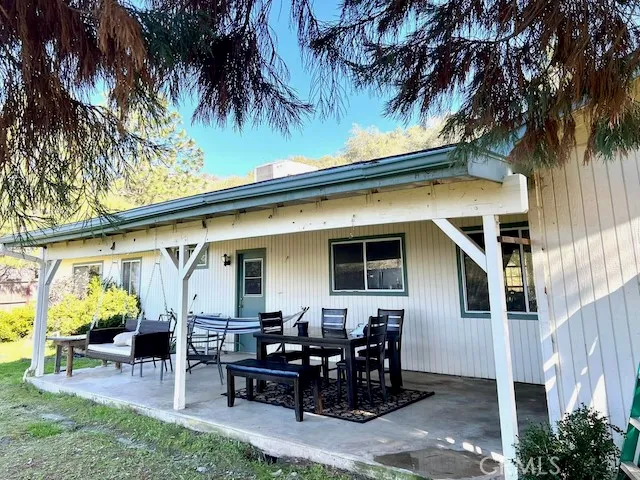 a view of a dinning table and chairs in patio of the house