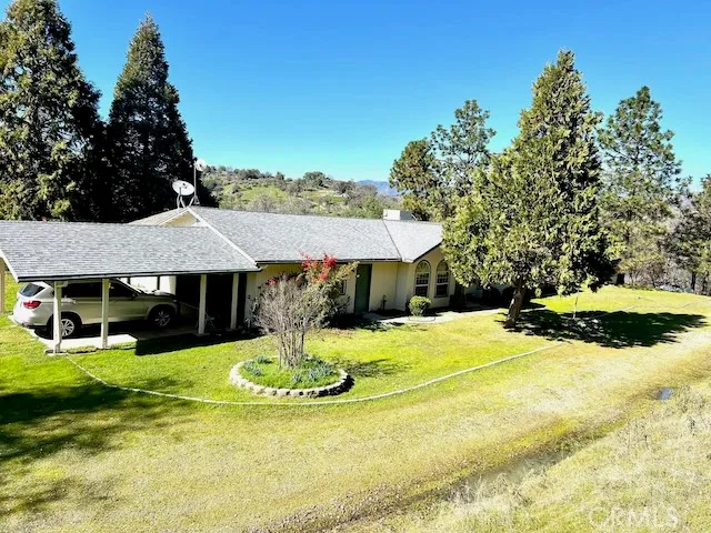 a view of a house with yard and sitting area