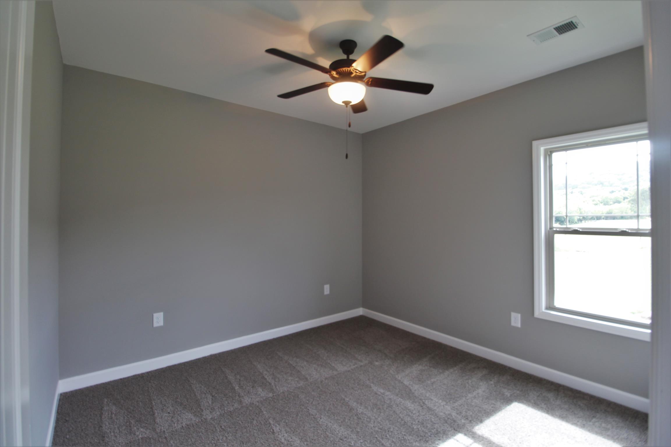 3840 Linwood Road Watertown, TN 37184 - Photo 16 of 23 an empty room with a window and a fan