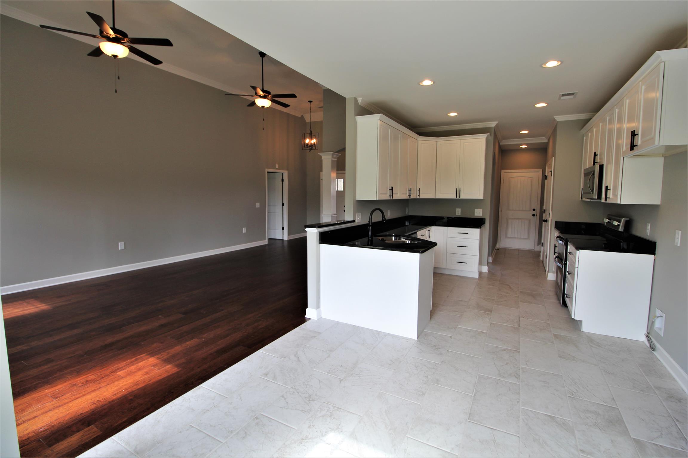 3840 Linwood Road Watertown, TN 37184 - Photo 5 of 23 a kitchen with kitchen island a sink stainless steel appliances and cabinets