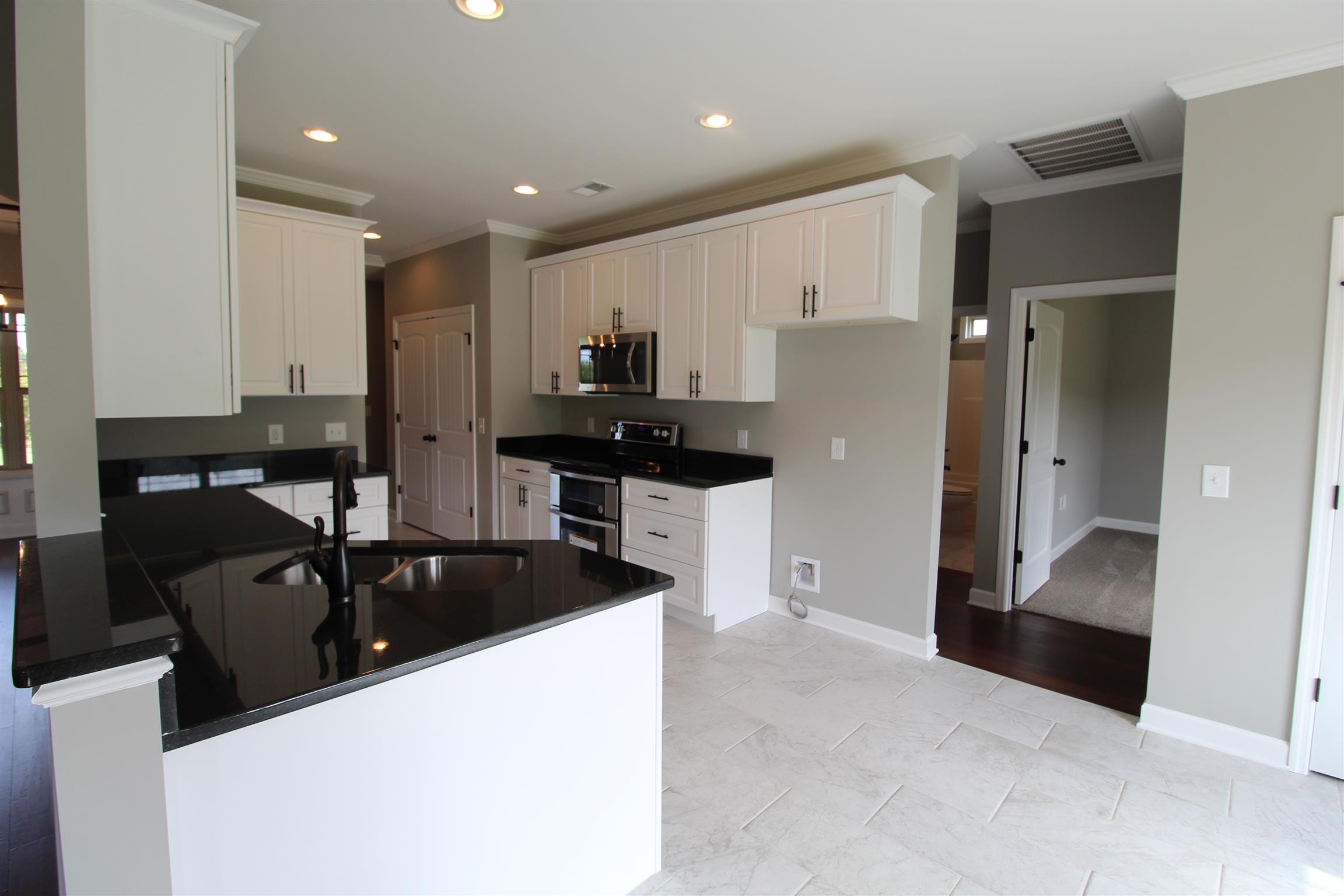 3840 Linwood Road Watertown, TN 37184 - Photo 7 of 23 a kitchen with granite countertop a refrigerator a sink a stove and cabinets
