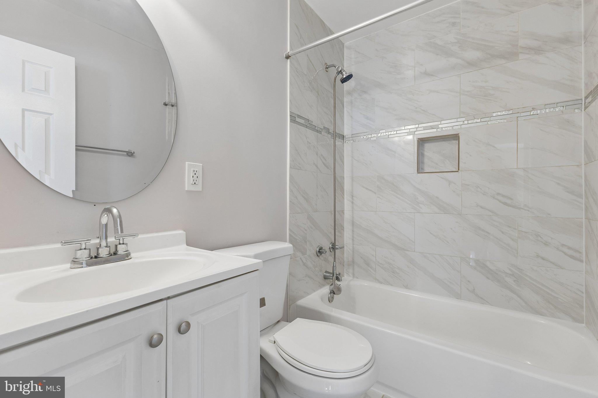 14197 Fullerton Road Woodbridge, VA 22193 - Photo 15 of 23 a bathroom with a sink a toilet and shower