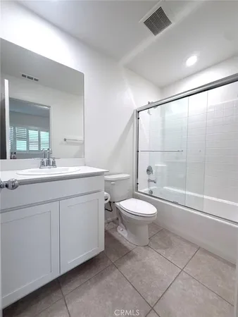 a bathroom with a double vanity sink toilet and shower