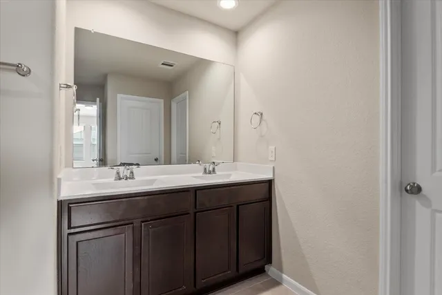 a bathroom with 2 sink and a mirror