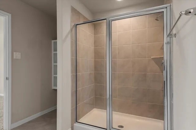 a bathroom with a glass shower door