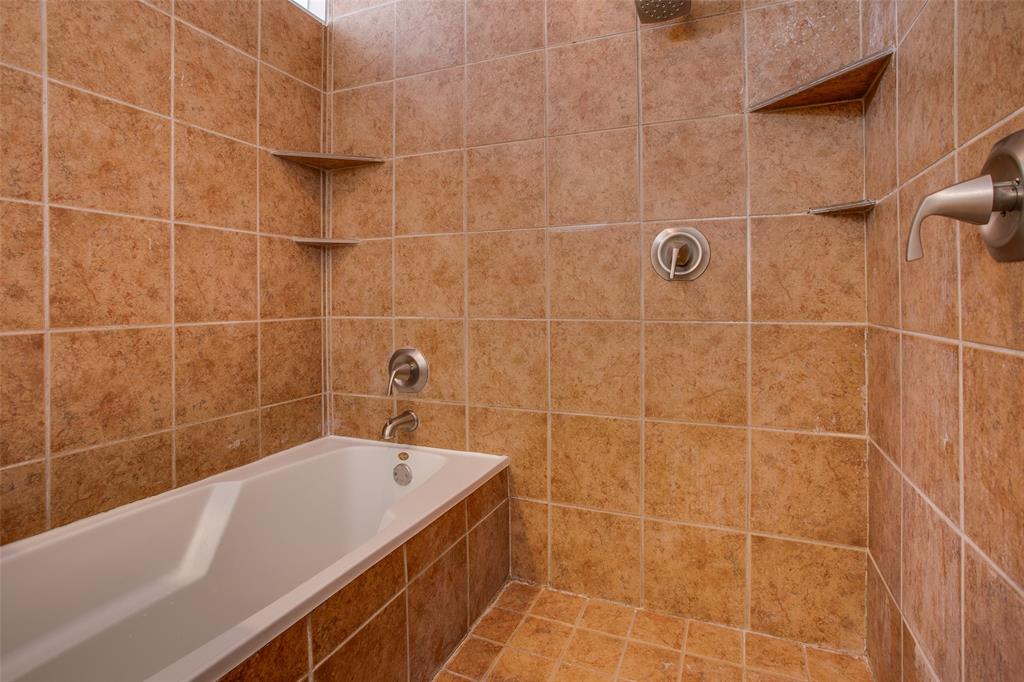 3840 San Jacinto Street Dallas, TX 75204 - Photo 25 of 34 a bathroom with a bathtub and a shower