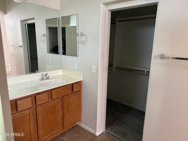 a bathroom with a sink vanity granite shower and a mirror