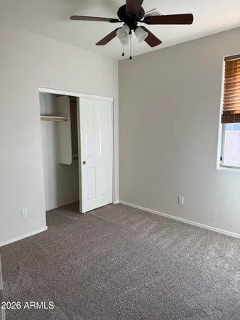 an empty room with a ceiling fan