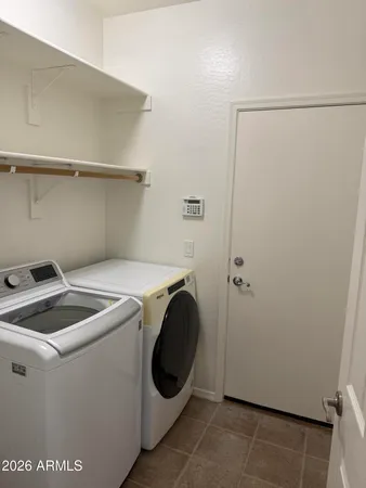 an empty room with a window and a ceiling fan