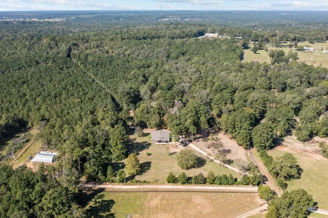 a large kitchen with stainless steel appliances kitchen island a sink granite counter tops and a view of living room