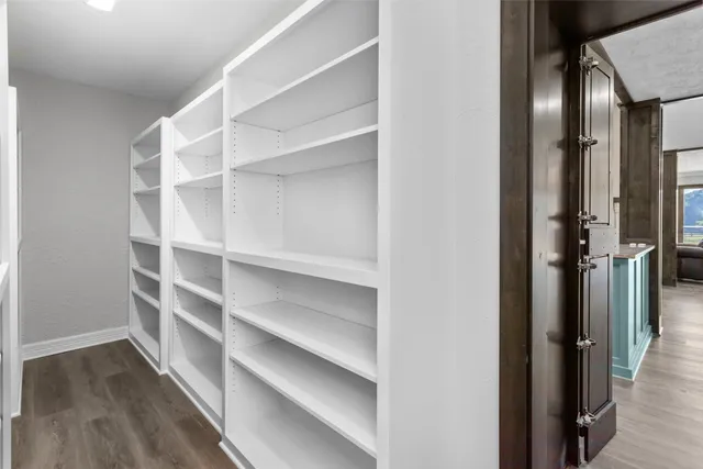 a view of a room with wooden floor and closet