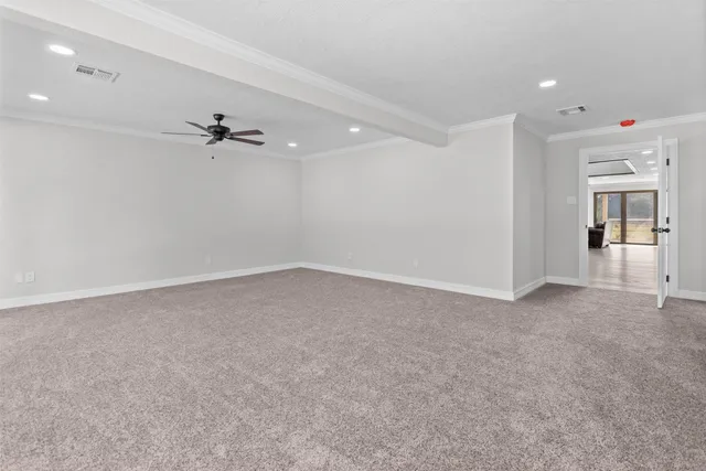 a view of a livingroom with a ceiling fan and window