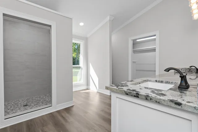 a bathroom with a granite countertop sink mirror and vanity