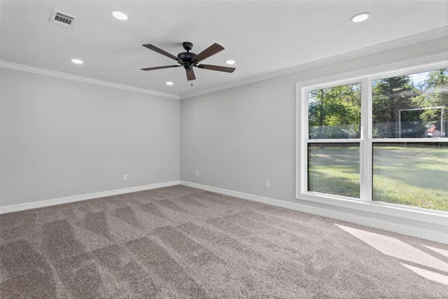 a view of a livingroom with a ceiling fan and window