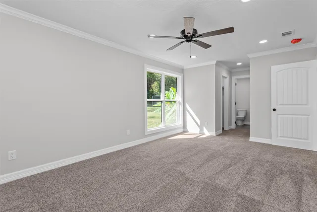 a bathroom with a granite countertop toilet sink and mirror
