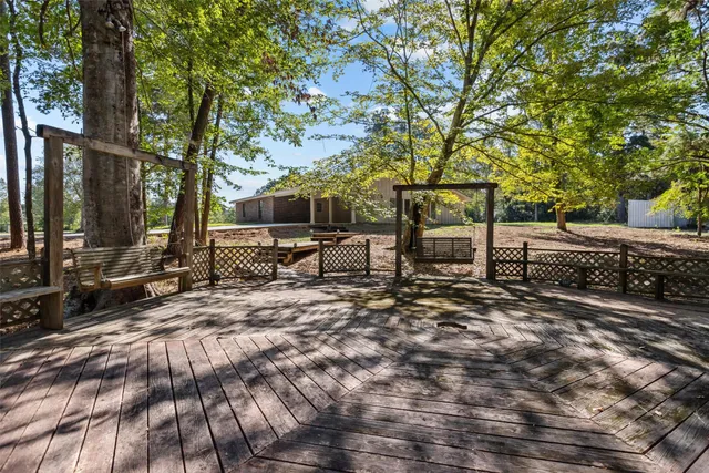 a large kitchen with stainless steel appliances granite countertop a lot of counter space and wooden floor