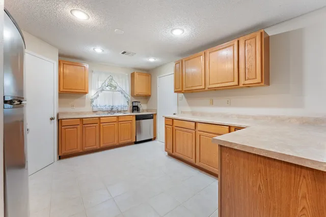 a kitchen with a sink cabinets and window