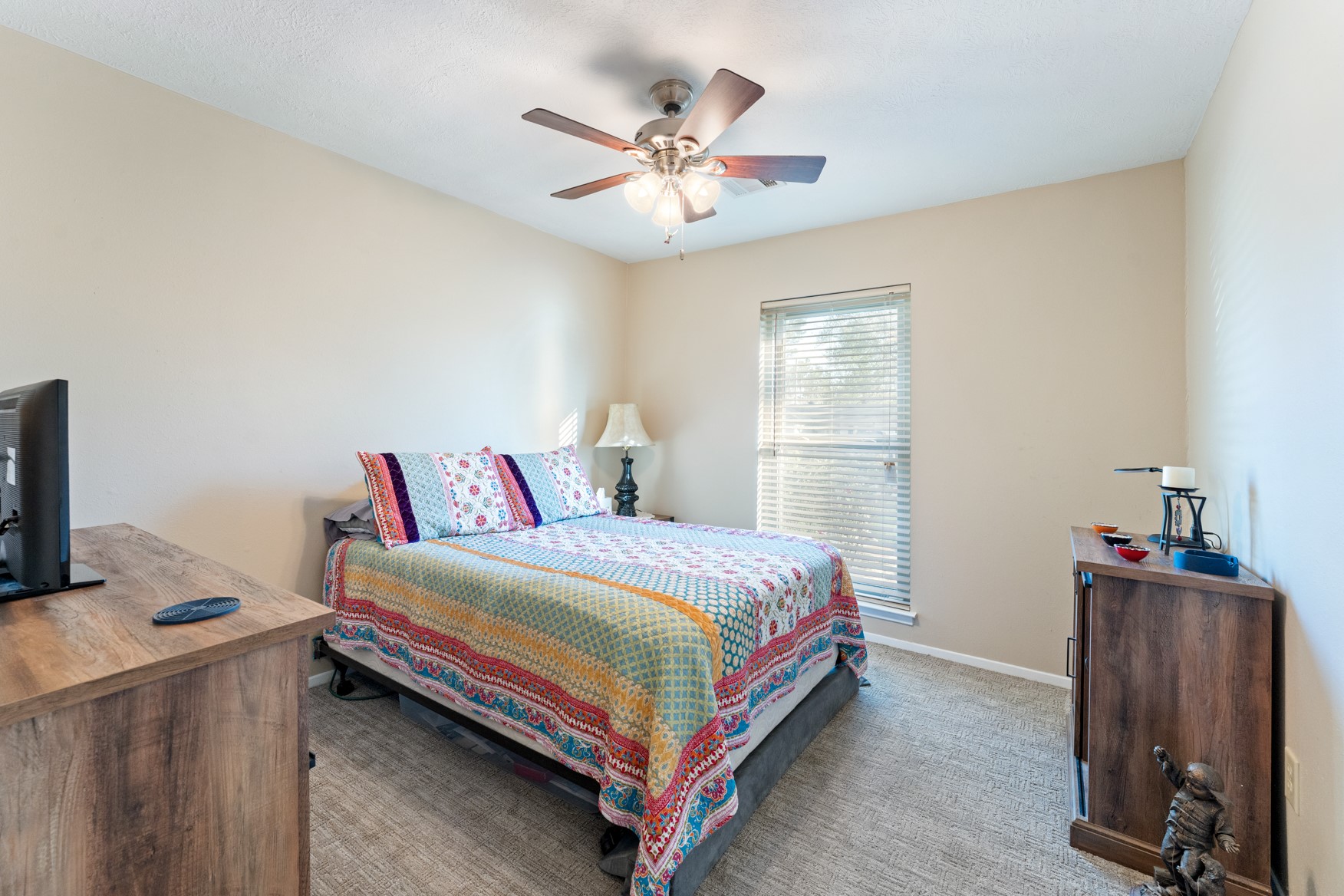 304 Hildred Avenue Conroe, TX 77303 - Photo 6 of 12 a bedroom with a bed and a table in it