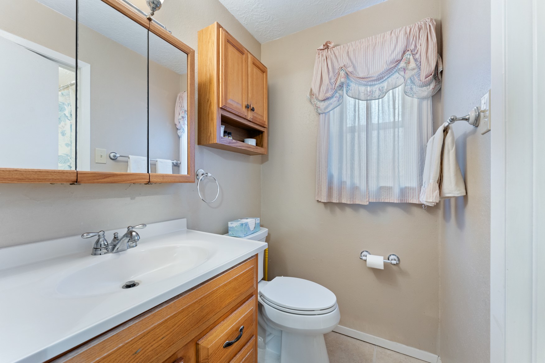 304 Hildred Avenue Conroe, TX 77303 - Photo 8 of 12 a bathroom with a sink a toilet and a mirror