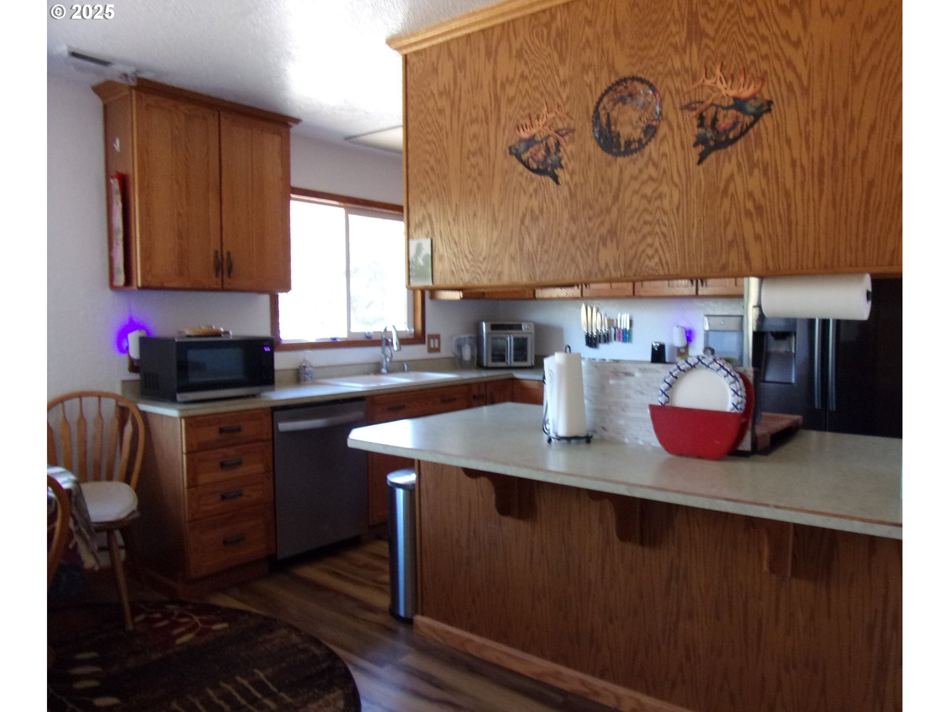 375 Jordan Creek Road Riddle, OR 97469 - Photo 20 of 35 a kitchen with a sink cabinets and wooden floor