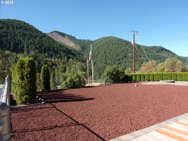 a view of a road with a house in the background