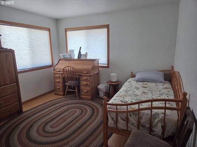 375 Jordan Creek Road Riddle, OR 97469 - Photo 31 of 35 a bedroom with a bed and wooden floor