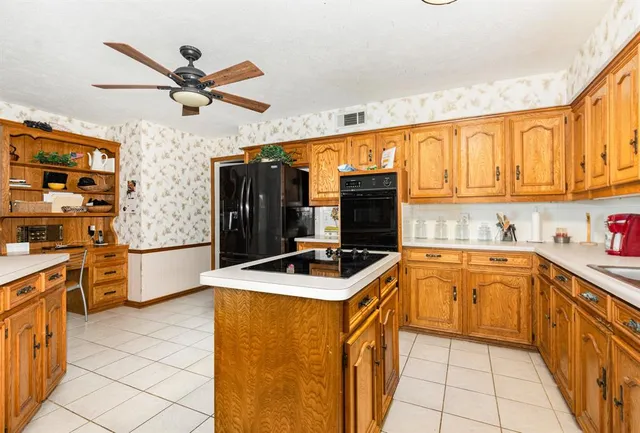 a kitchen with stainless steel appliances a stove sink and cabinets