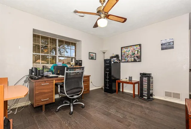 a view of a workspace with furniture and a window