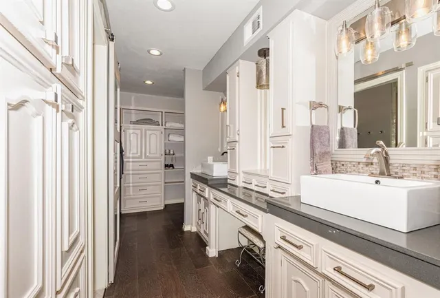 a kitchen with a sink appliances and cabinets